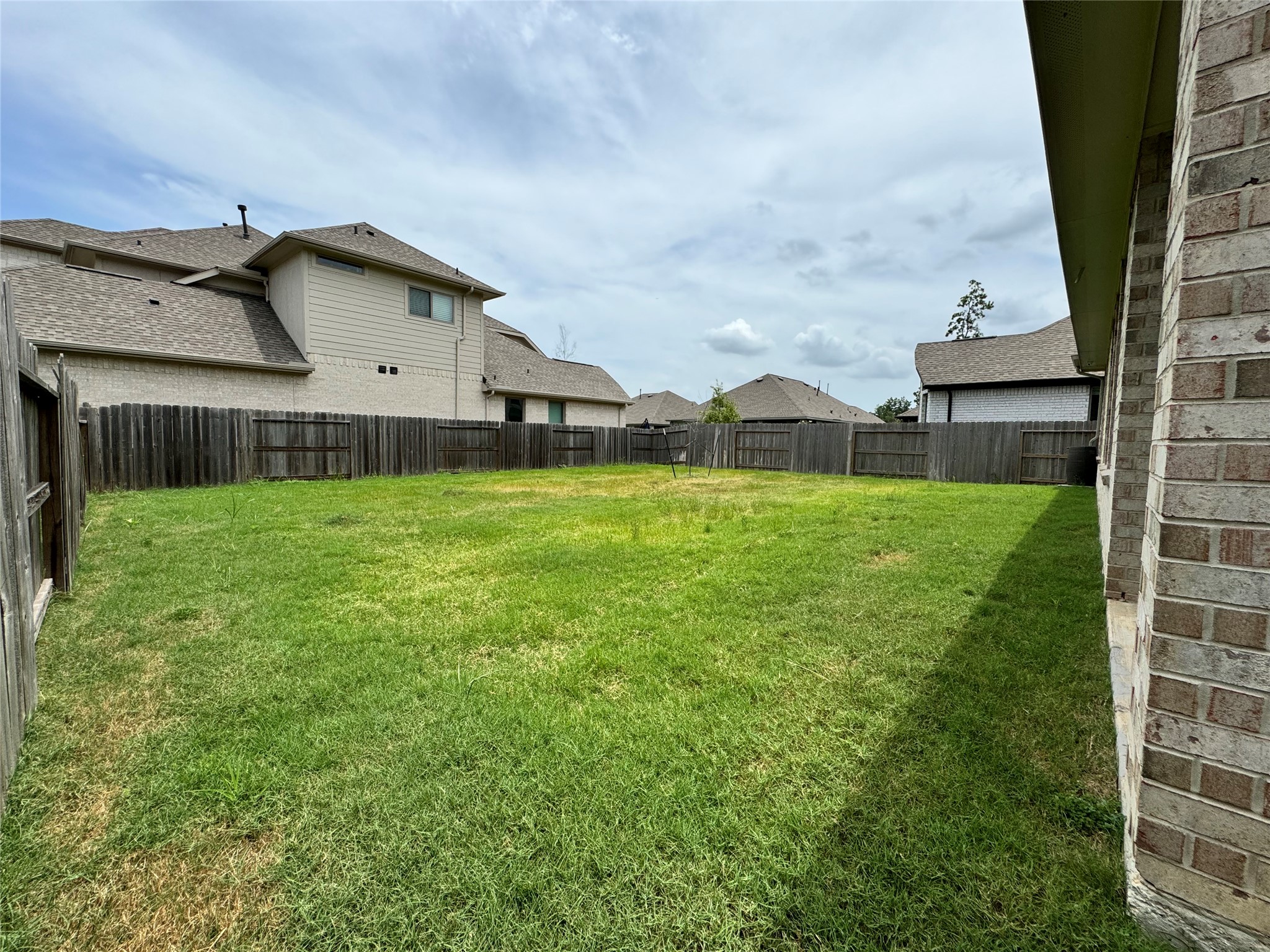 17311 Grand Canyon Road Conroe, TX 77302 - Photo 27 of 28 a view of a house with a yard