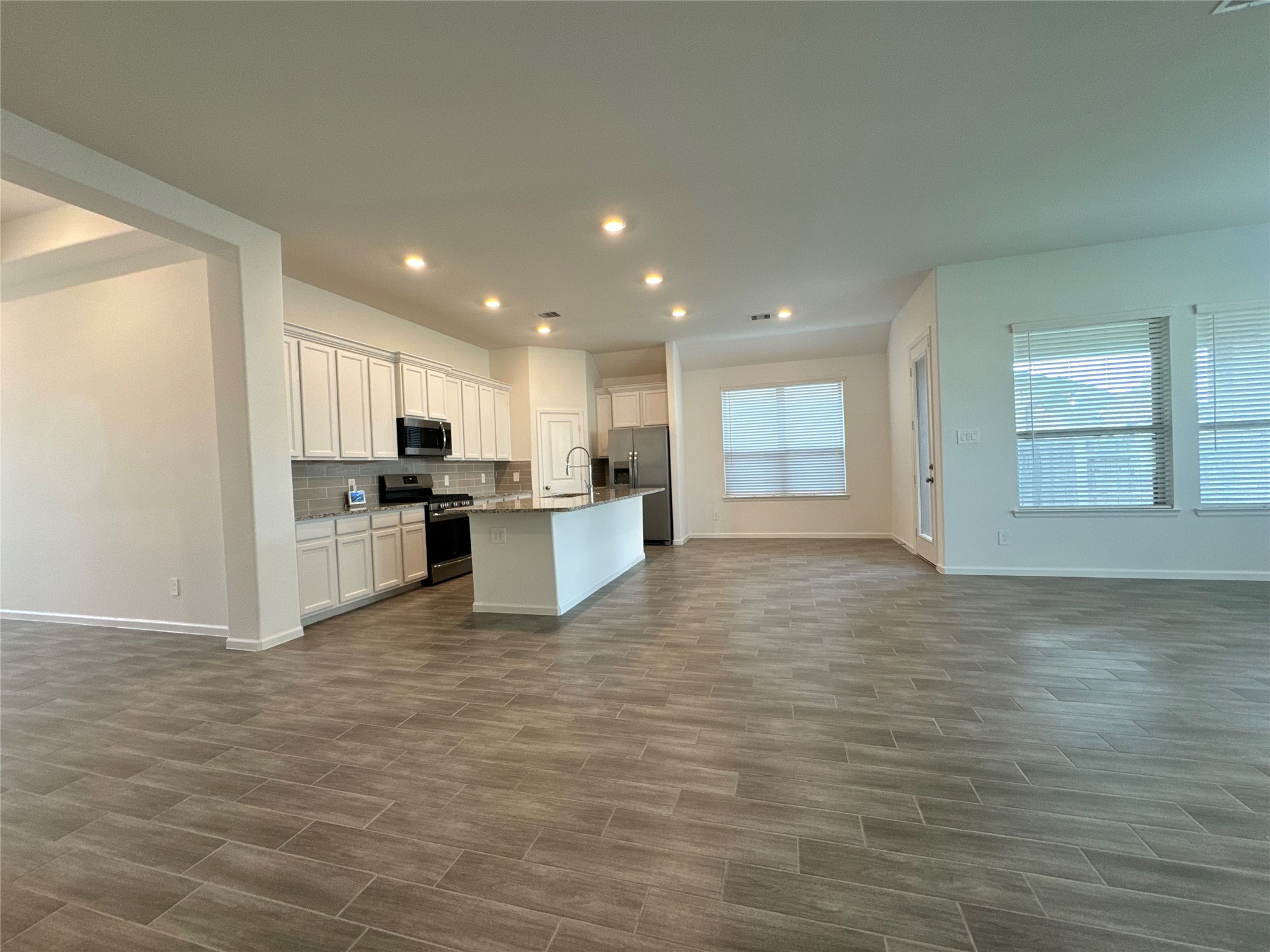 17311 Grand Canyon Road Conroe, TX 77302 - Photo 6 of 28 a view of kitchen with kitchen island wooden floor center island and stainless steel appliances