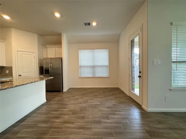 a large kitchen with stainless steel appliances granite countertop a large counter top a refrigerator and a stove