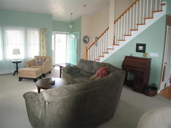 251 Mill Road Fairhaven, MA 02719 - Photo 11 of 14 a living room with couches and a potted plant on table with wooden floor