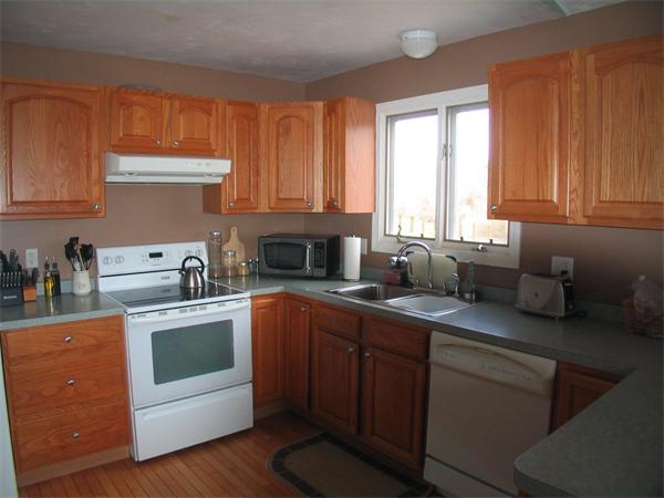 251 Mill Road Fairhaven, MA 02719 - Photo 7 of 14 a kitchen with stainless steel appliances granite countertop a sink stove and cabinets