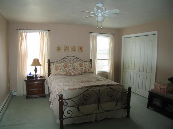 251 Mill Road Fairhaven, MA 02719 - Photo 8 of 14 a bedroom with a bed and a chandelier