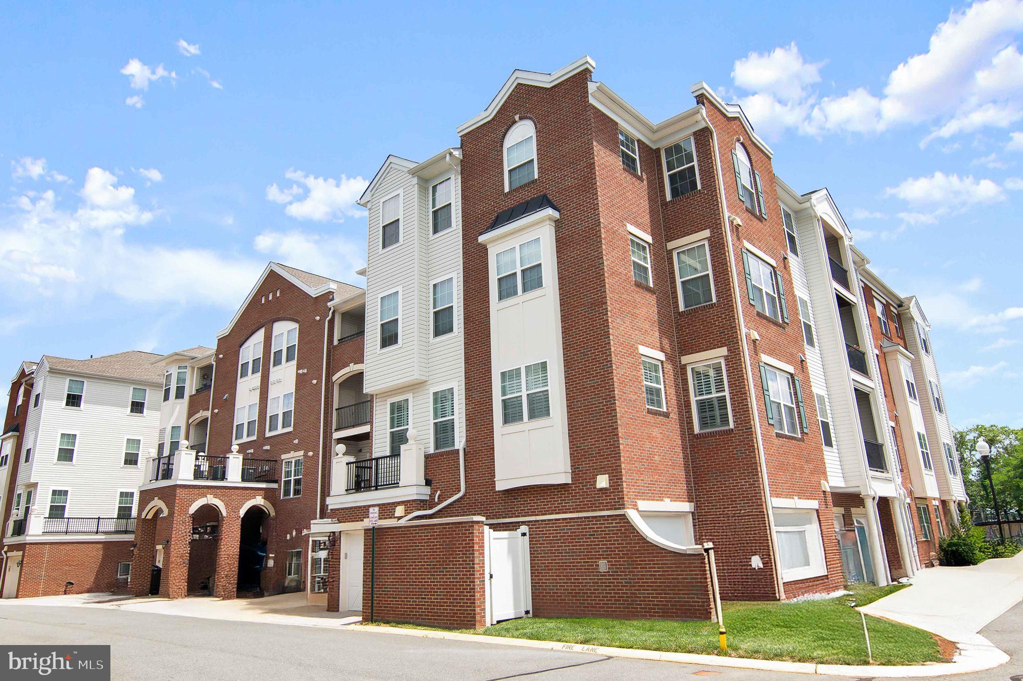 a front view of a residential apartment building with a yard
