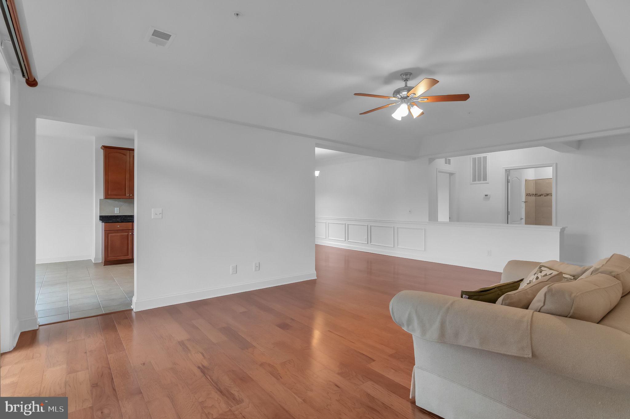 10273A Fountain Circle, Unit 306 Manassas, VA 20110 - Photo 11 of 33 a living room with furniture and a chandelier