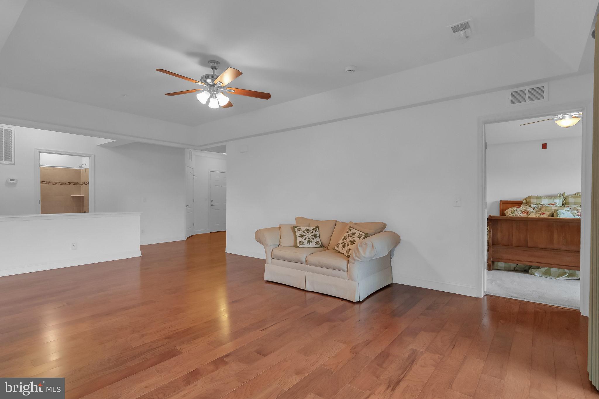 10273A Fountain Circle, Unit 306 Manassas, VA 20110 - Photo 12 of 33 a living room with furniture and a chandelier