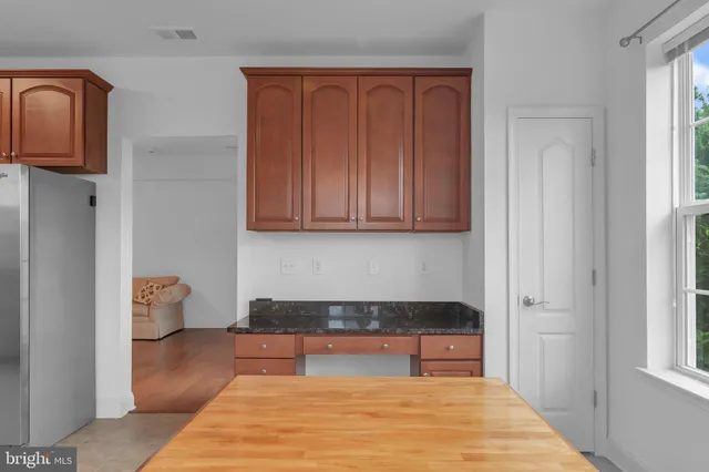 a living room with wooden floor and a cabinet