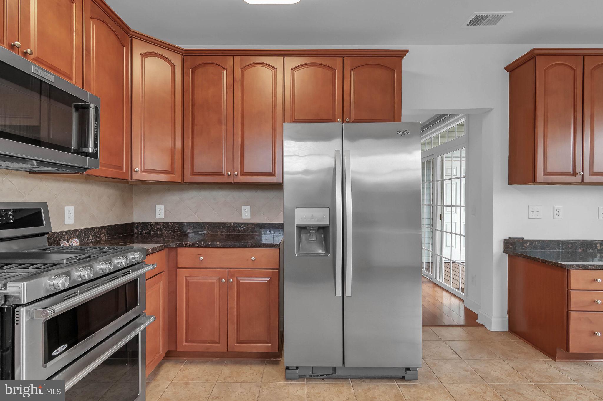 10273A Fountain Circle, Unit 306 Manassas, VA 20110 - Photo 20 of 33 a kitchen with stainless steel appliances granite countertop a refrigerator stove and microwave