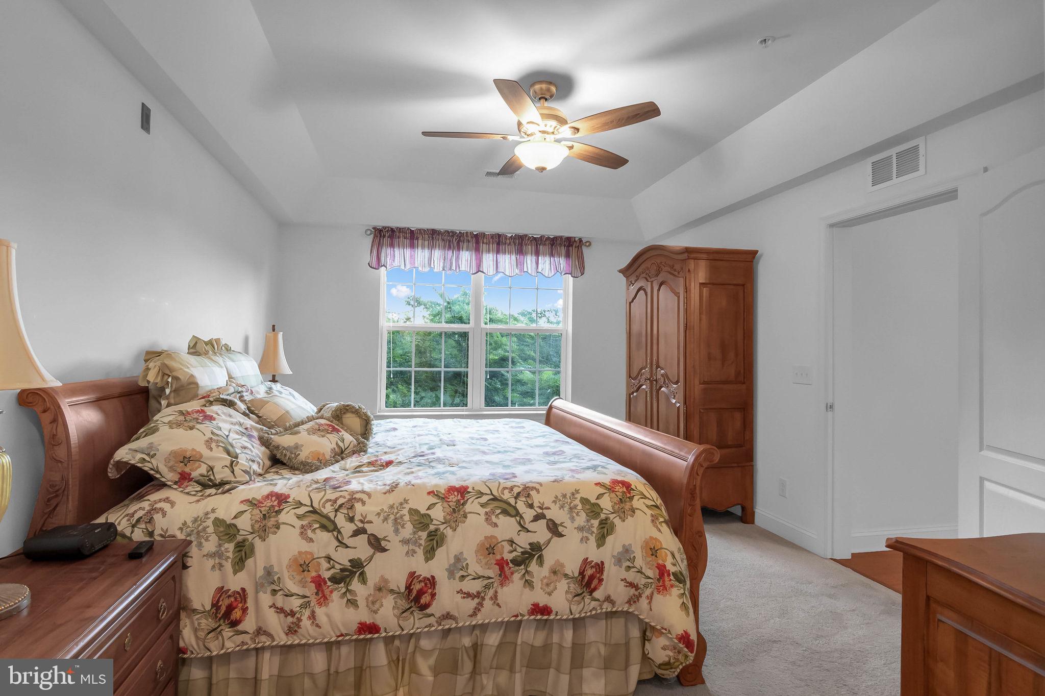 10273A Fountain Circle, Unit 306 Manassas, VA 20110 - Photo 23 of 33 a bedroom with a bed and a chandelier