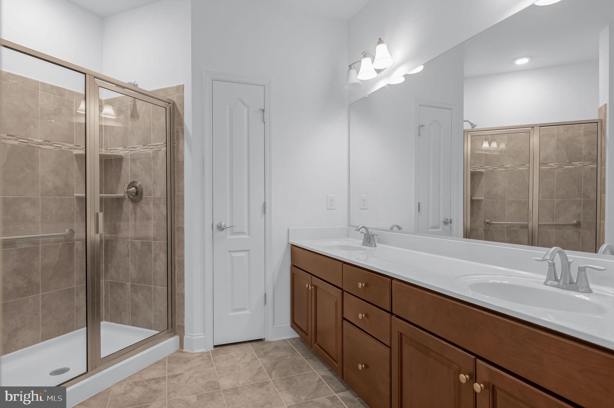 10273A Fountain Circle, Unit 306 Manassas, VA 20110 - Photo 27 of 33 a bathroom with a double vanity sink mirror and shower