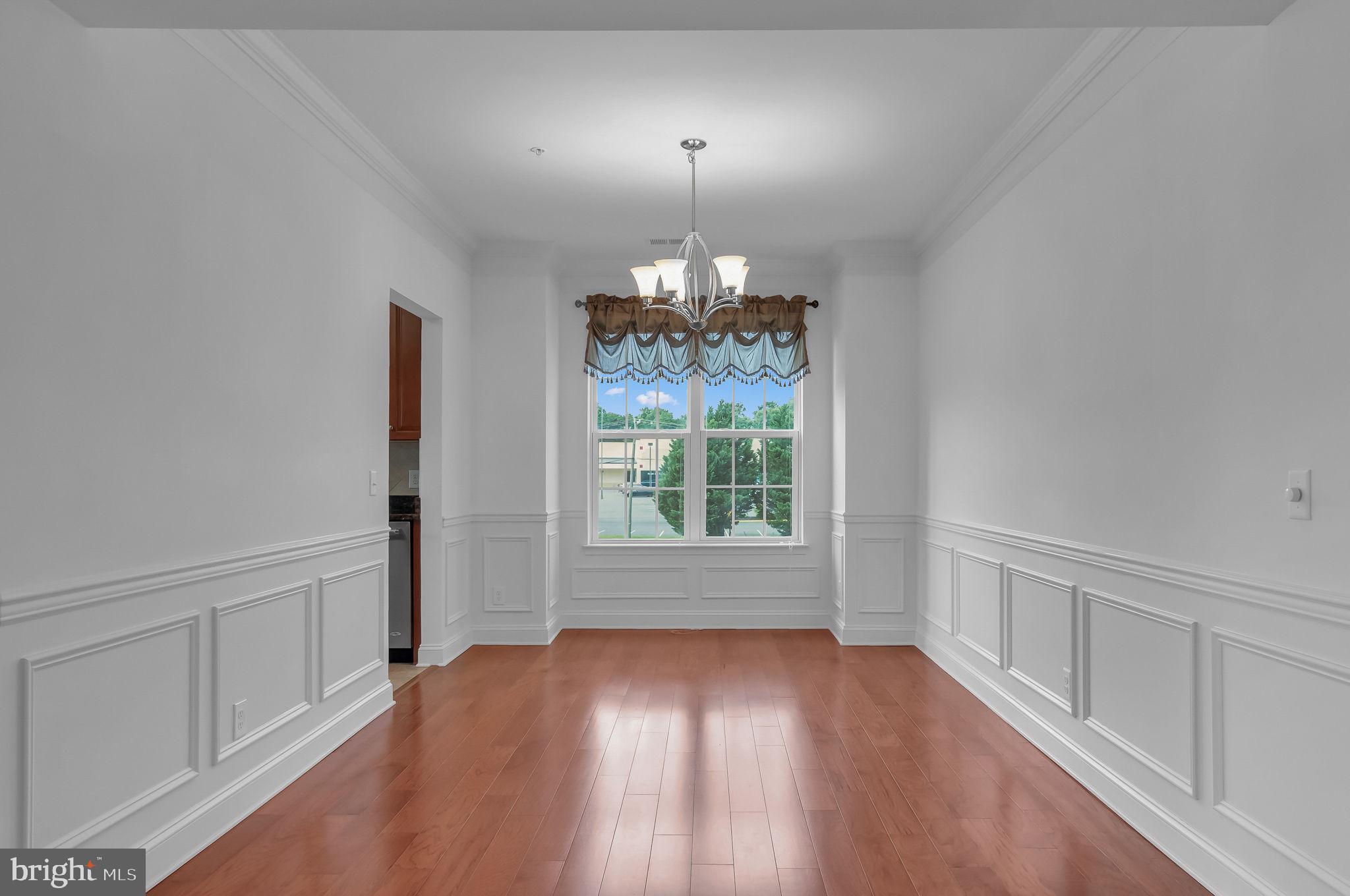 10273A Fountain Circle, Unit 306 Manassas, VA 20110 - Photo 10 of 33 wooden floor in an empty room with a window