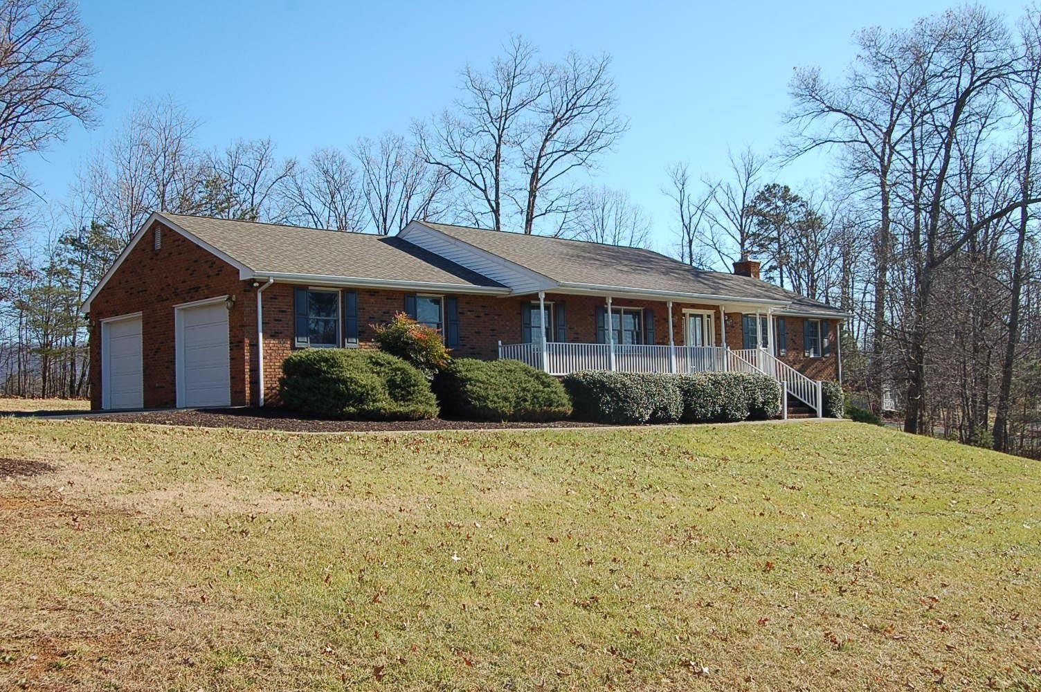 198 Oak Ridge Court Blue Ridge, VA 24064 - Photo 1 of 33 a front view of a house with a garden