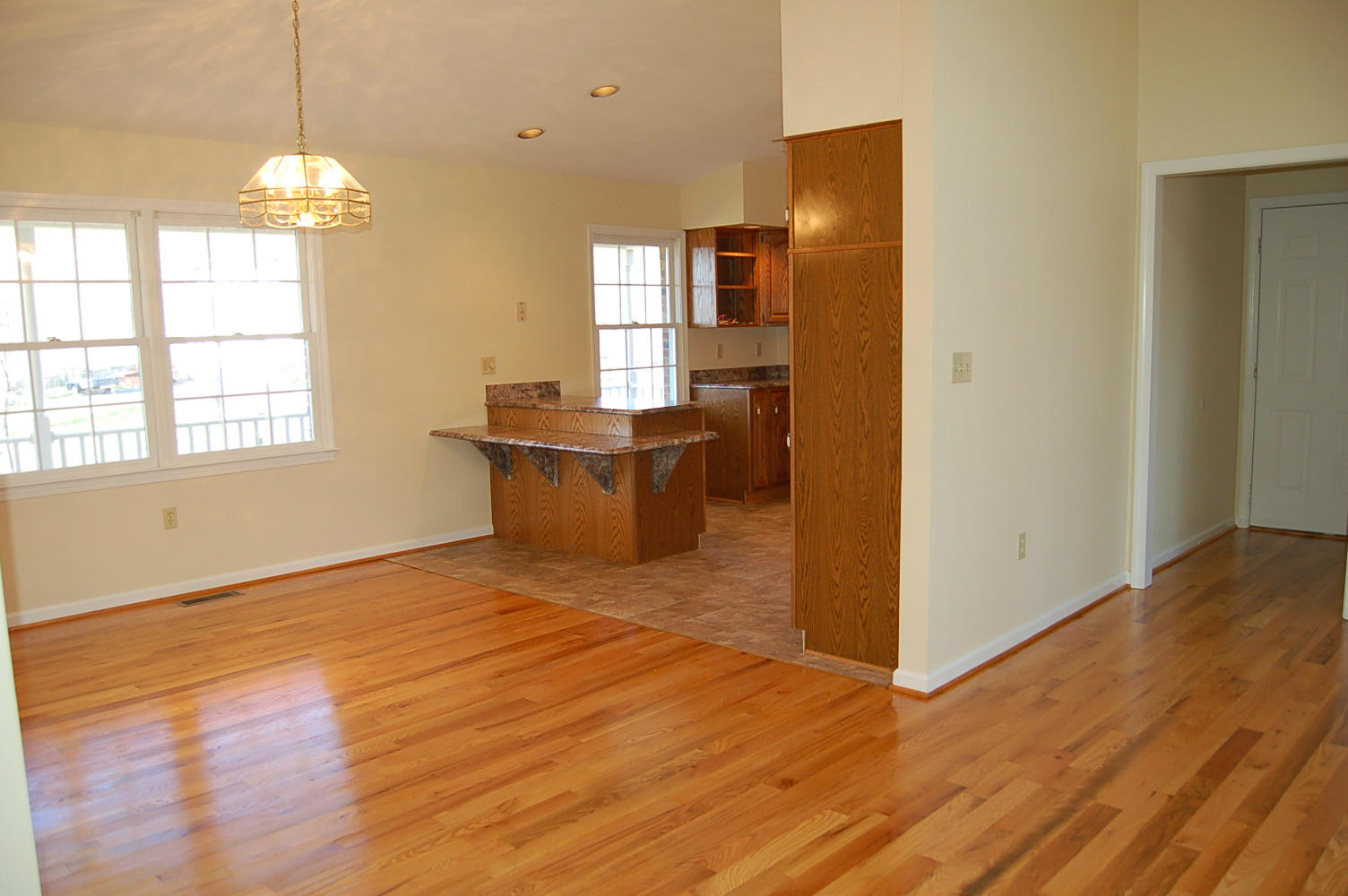 198 Oak Ridge Court Blue Ridge, VA 24064 - Photo 12 of 33 a view of an empty room with wooden floor and a window