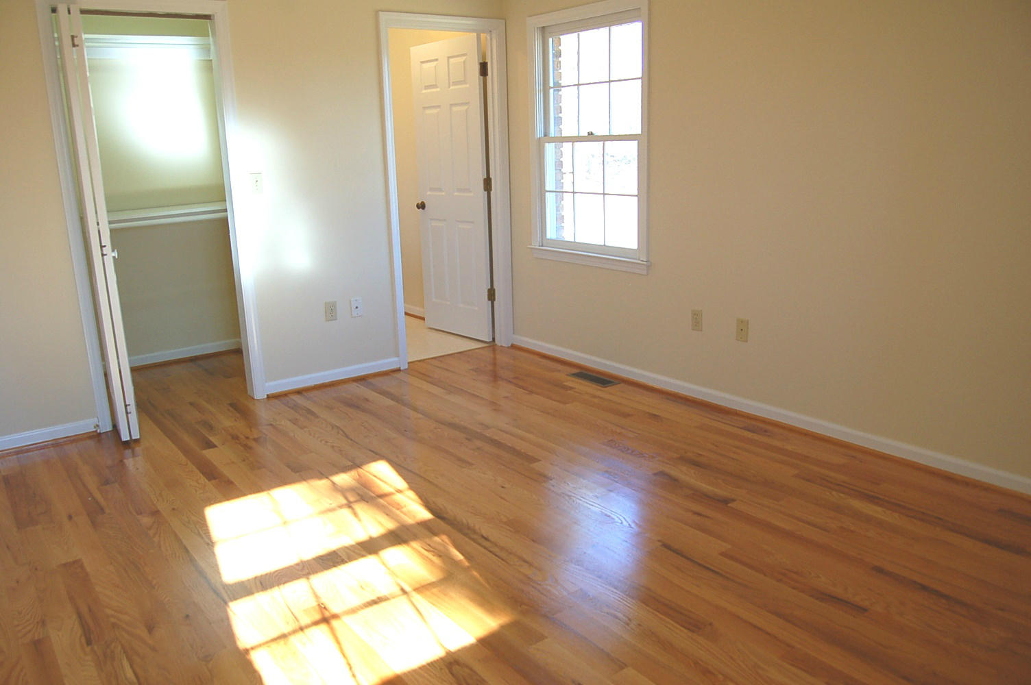 198 Oak Ridge Court Blue Ridge, VA 24064 - Photo 14 of 33 an empty room with wooden floor and windows