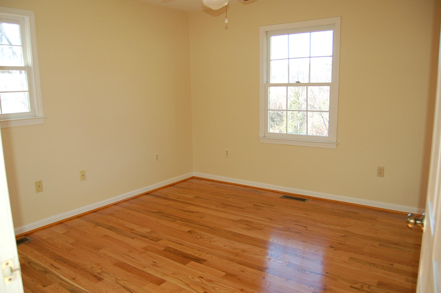 198 Oak Ridge Court Blue Ridge, VA 24064 - Photo 15 of 33 an empty room with wooden floor and windows
