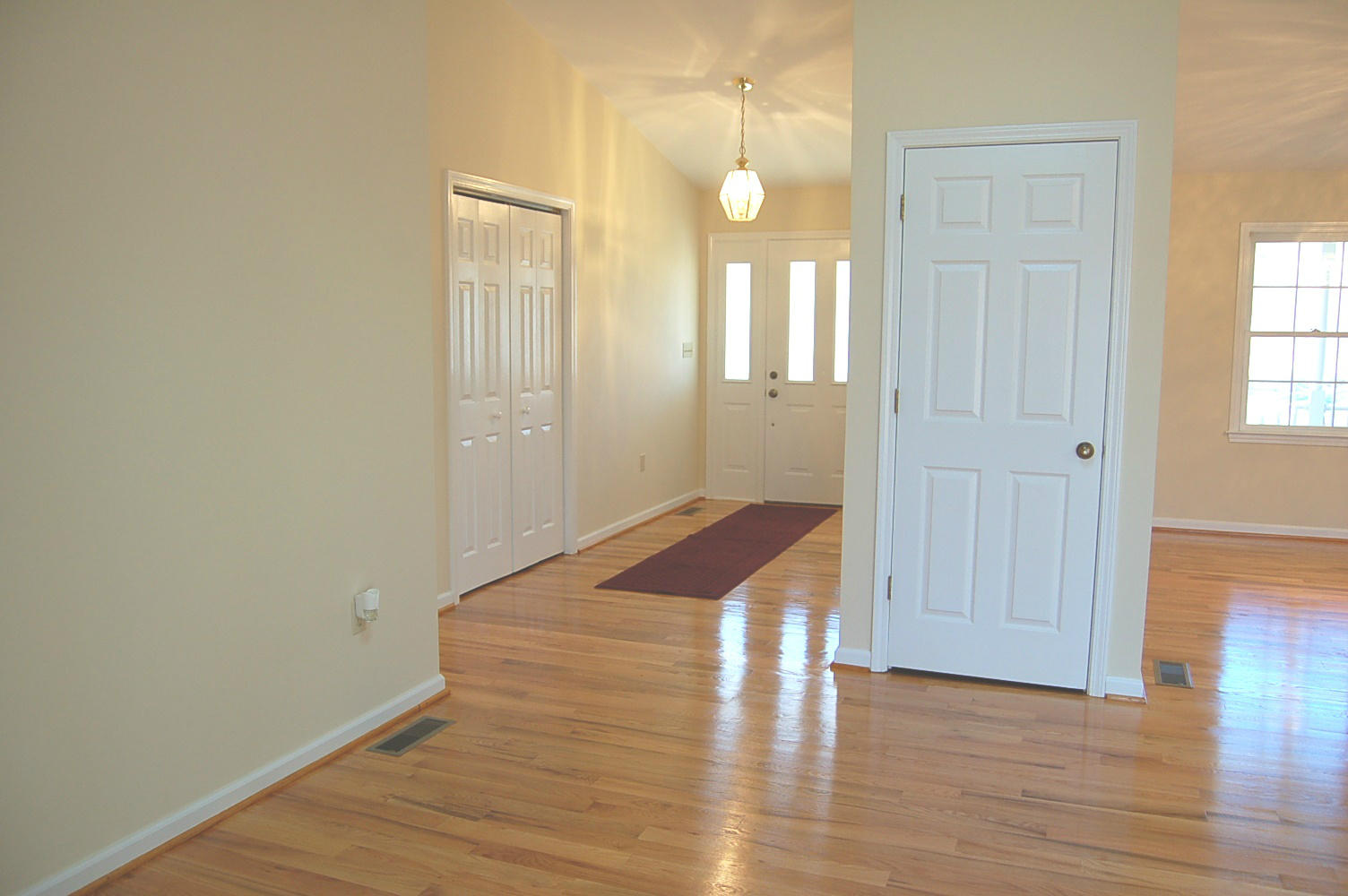 198 Oak Ridge Court Blue Ridge, VA 24064 - Photo 6 of 33 an empty room with wooden floor and windows