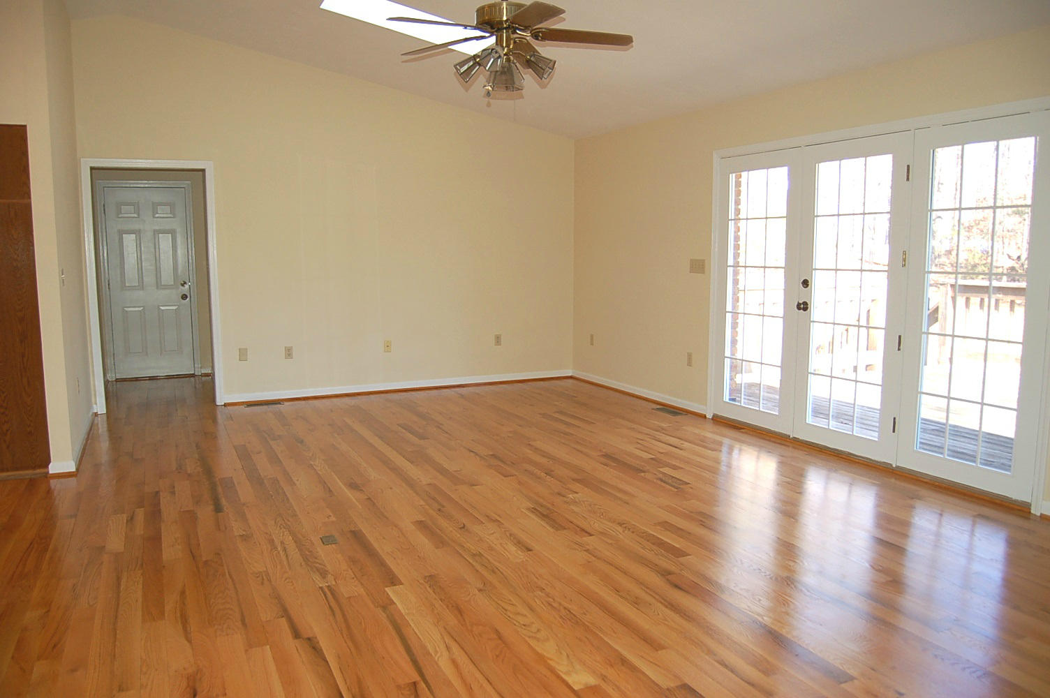 198 Oak Ridge Court Blue Ridge, VA 24064 - Photo 7 of 33 wooden floor in an empty room with a window
