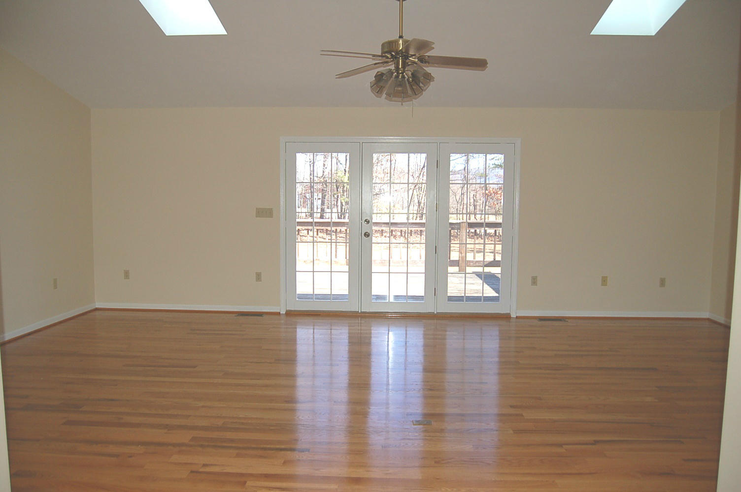 198 Oak Ridge Court Blue Ridge, VA 24064 - Photo 8 of 33 a view of an empty room with wooden floor and a window