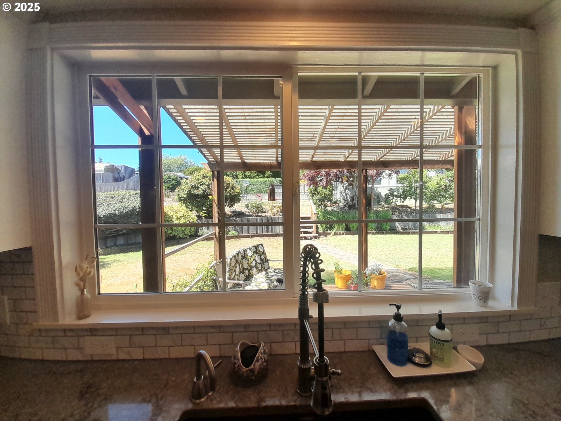 3449 Northeast West Devils Lake Road Lincoln City, OR 97367 - Photo 11 of 48 a bathroom with a sink and a large window