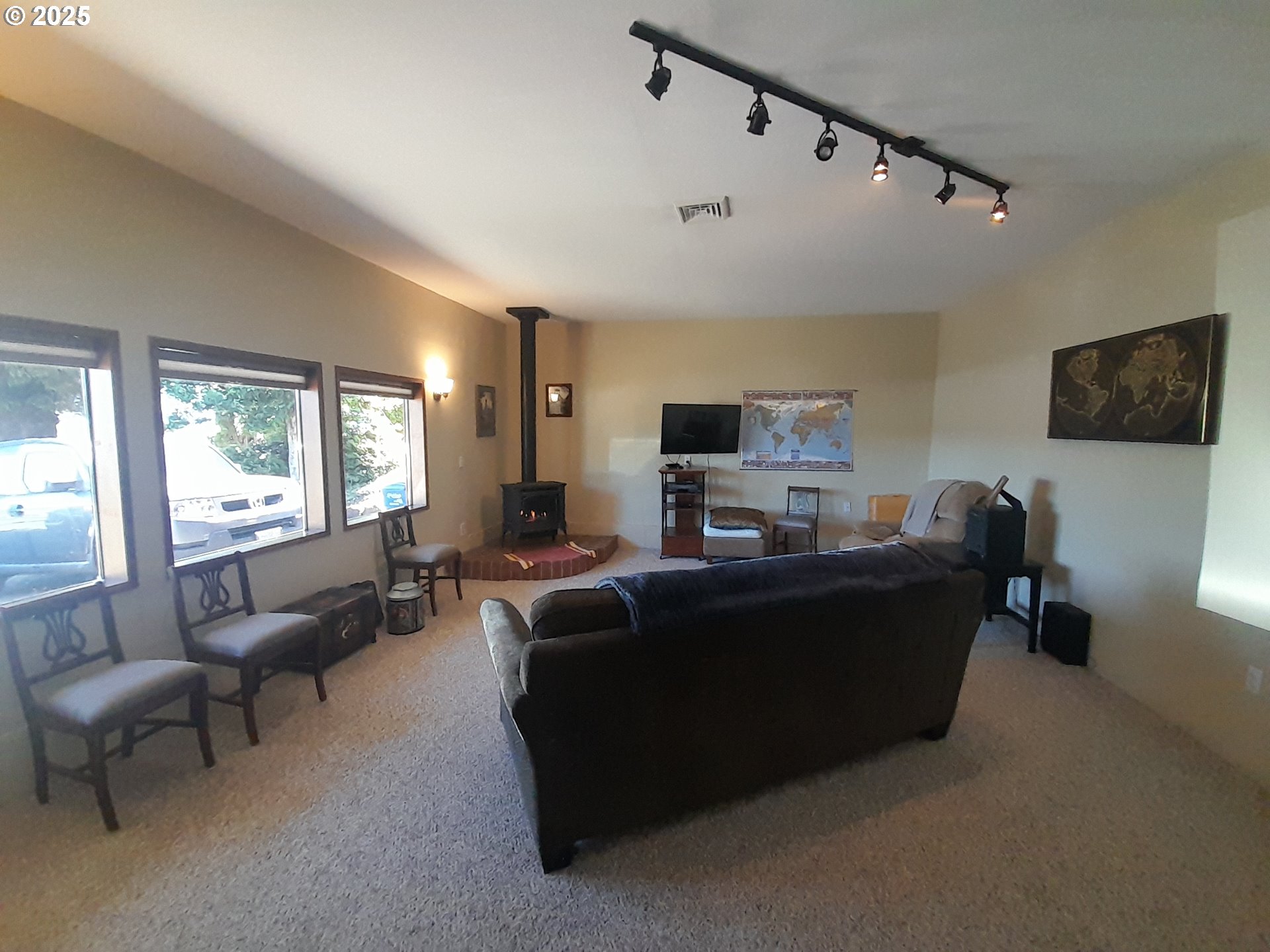 3449 Northeast West Devils Lake Road Lincoln City, OR 97367 - Photo 12 of 48 a living room with furniture and a flat screen tv