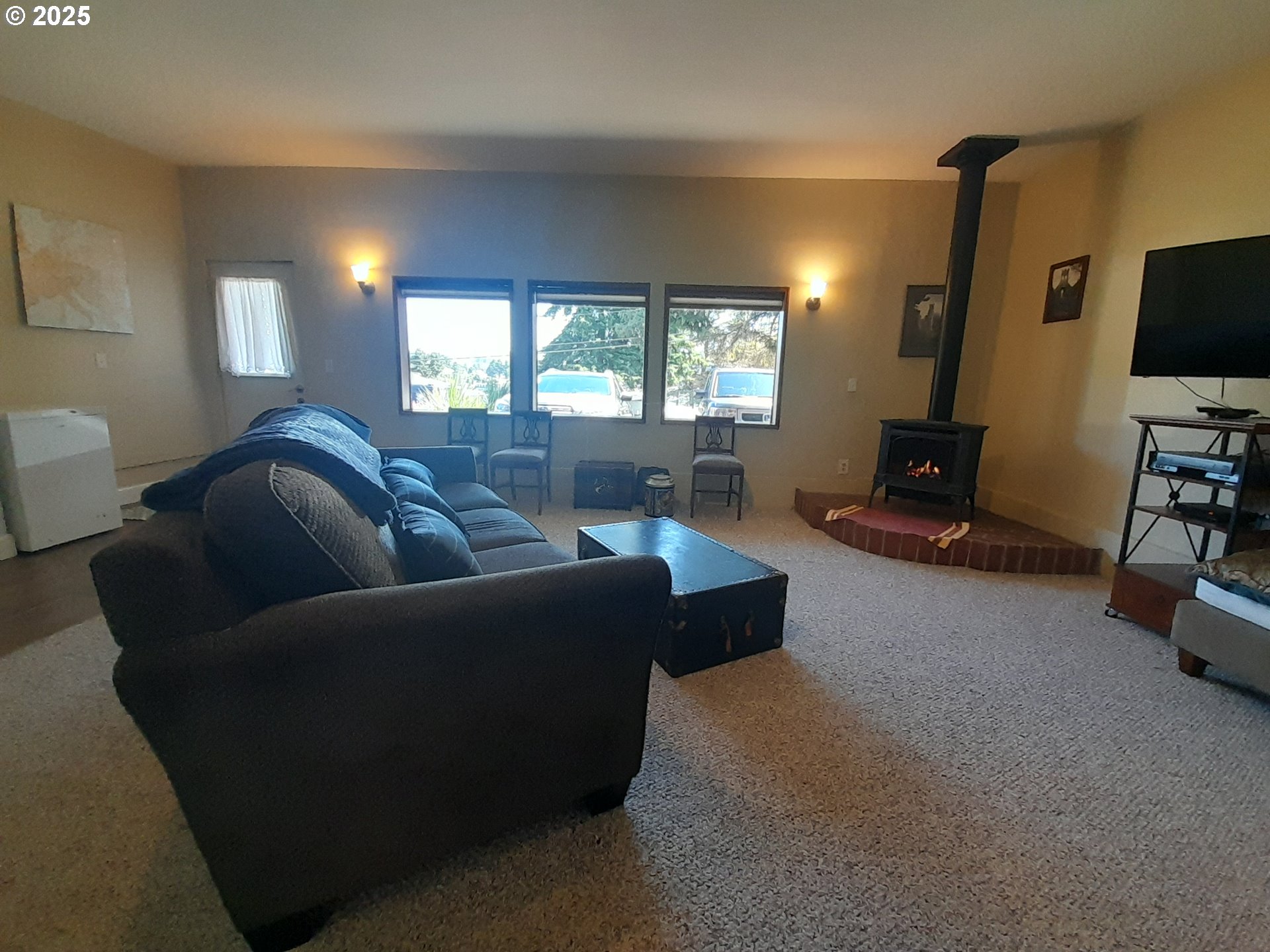 3449 Northeast West Devils Lake Road Lincoln City, OR 97367 - Photo 16 of 48 a living room with furniture and a flat screen tv