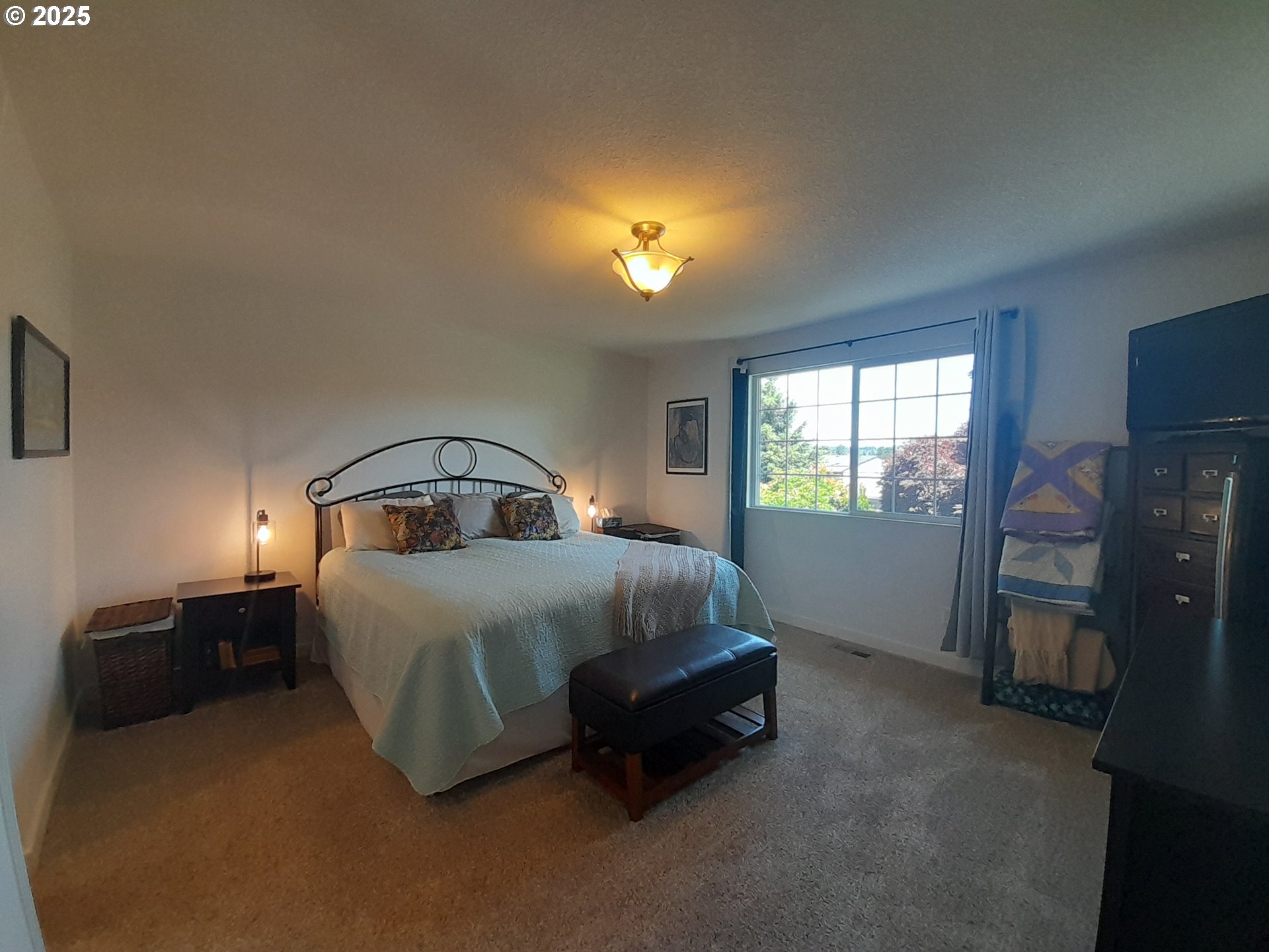 3449 Northeast West Devils Lake Road Lincoln City, OR 97367 - Photo 17 of 48 a bedroom with a bed and a window