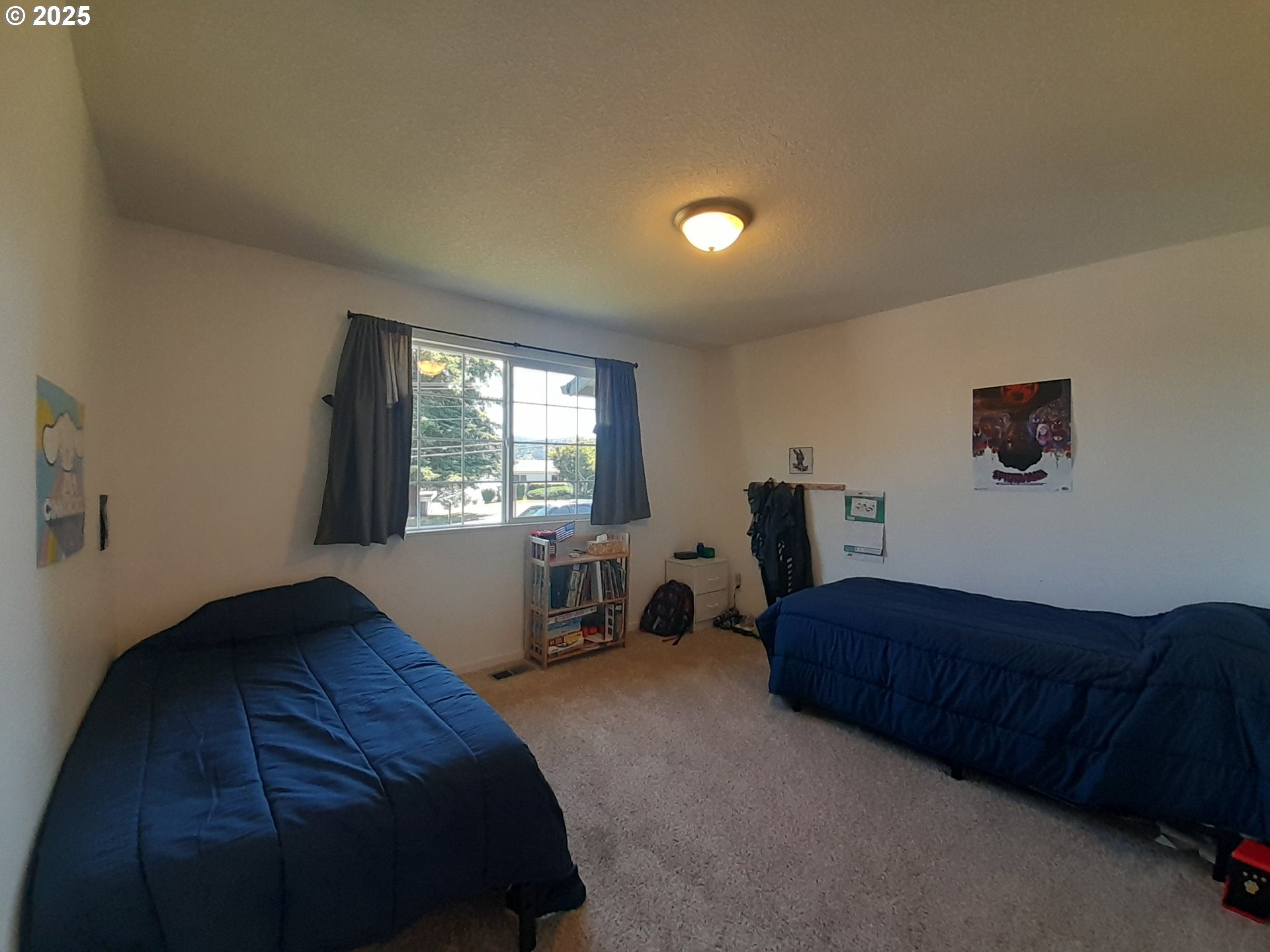 3449 Northeast West Devils Lake Road Lincoln City, OR 97367 - Photo 21 of 48 a bedroom with a bed and window