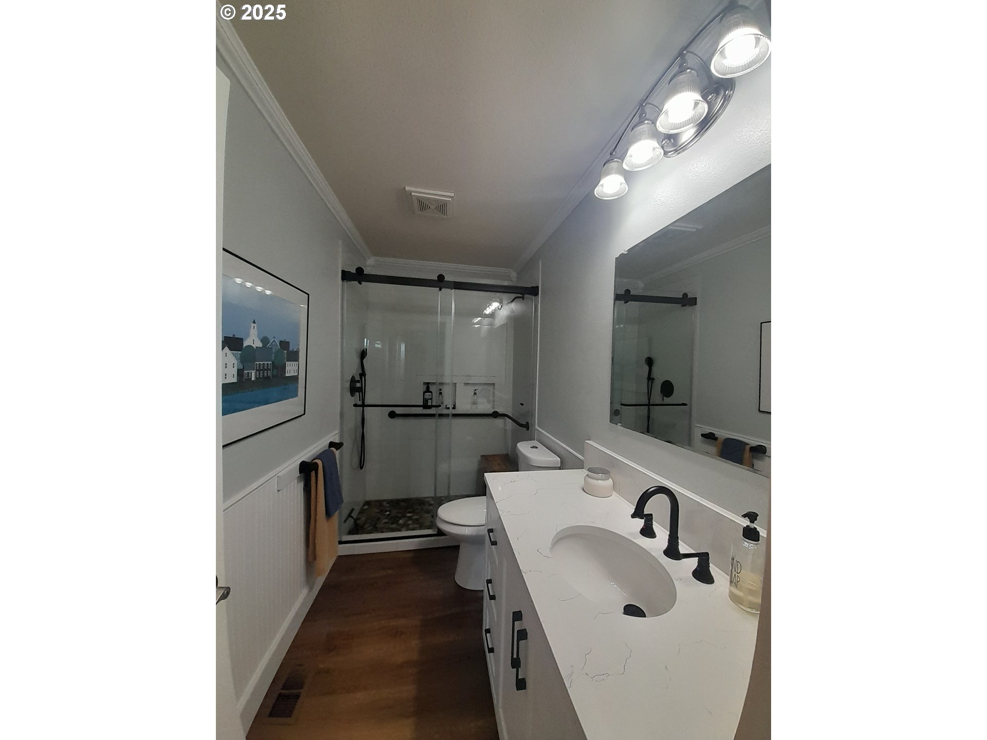 3449 Northeast West Devils Lake Road Lincoln City, OR 97367 - Photo 23 of 48 a bathroom with a sink a mirror and a toilet