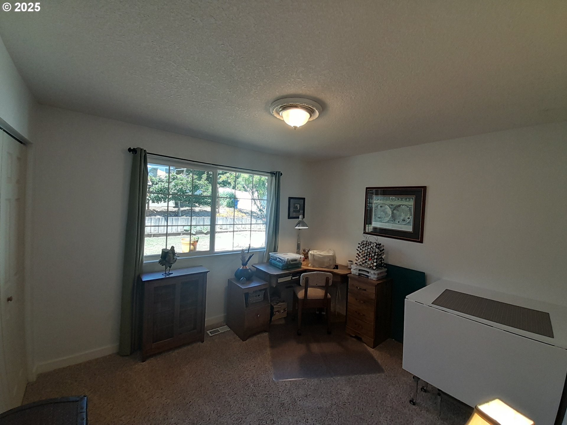 3449 Northeast West Devils Lake Road Lincoln City, OR 97367 - Photo 24 of 48 a view of a workspace with furniture and a window