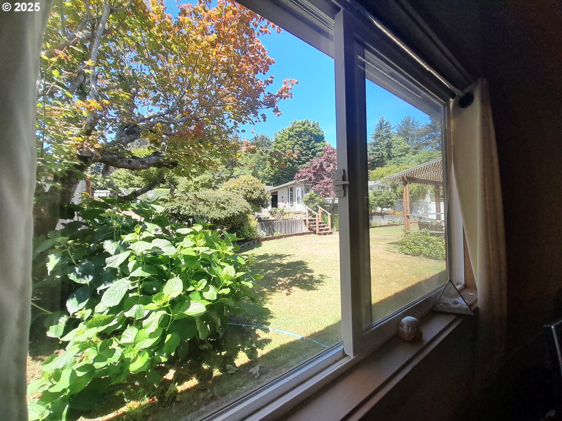 3449 Northeast West Devils Lake Road Lincoln City, OR 97367 - Photo 26 of 48 a view of a back yard from a window