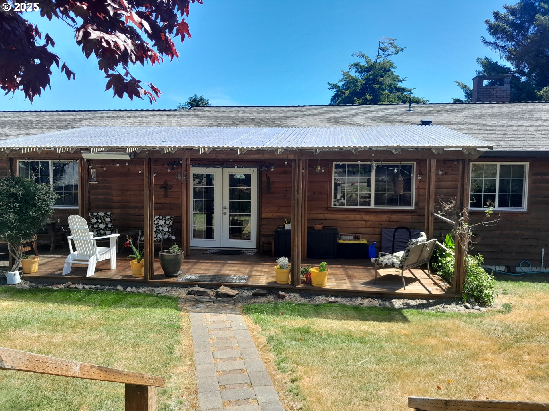 3449 Northeast West Devils Lake Road Lincoln City, OR 97367 - Photo 28 of 48 a view of a house with backyard porch and sitting area