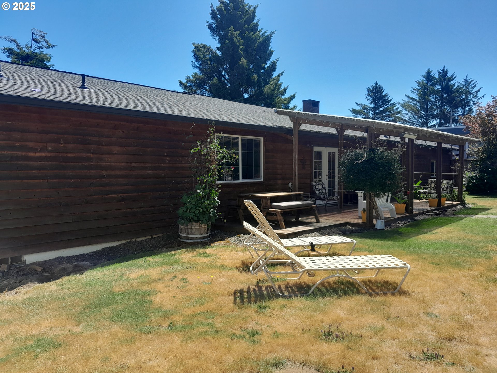 3449 Northeast West Devils Lake Road Lincoln City, OR 97367 - Photo 29 of 48 a view of a backyard with a patio
