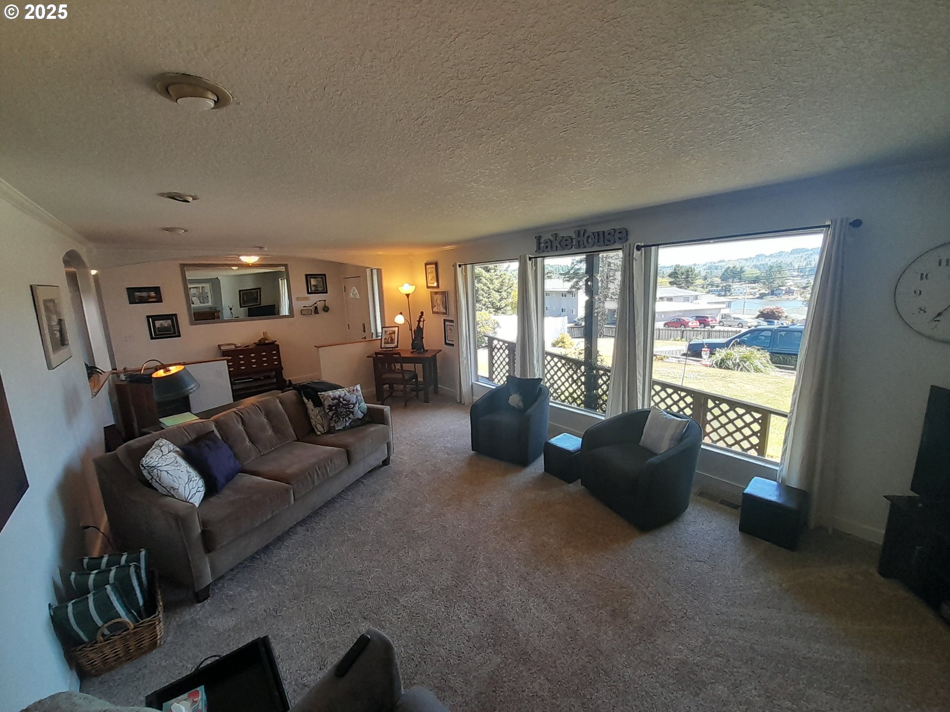 3449 Northeast West Devils Lake Road Lincoln City, OR 97367 - Photo 3 of 48 a living room with furniture and a large window