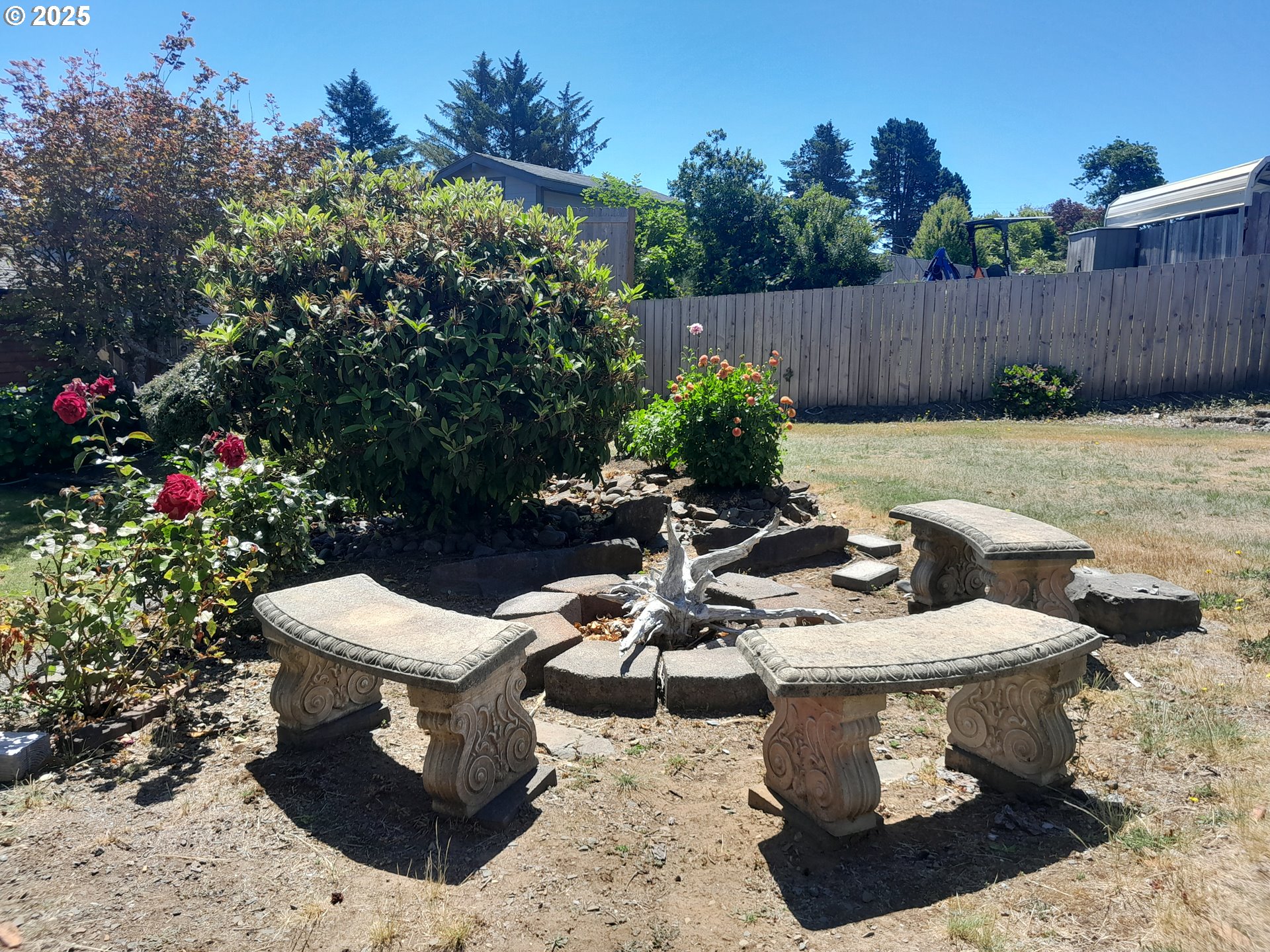 3449 Northeast West Devils Lake Road Lincoln City, OR 97367 - Photo 33 of 48 a view of a chairs and table in backyard