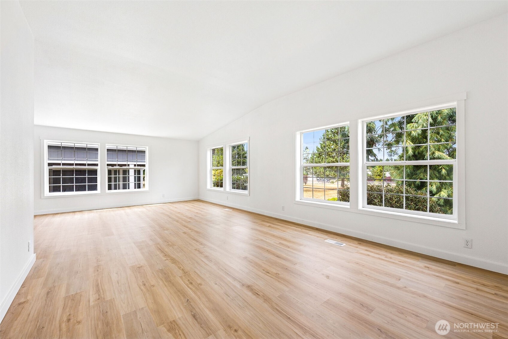 125 Highland Road Winlock, WA 98596 - Photo 5 of 40 an empty room with wooden floor and windows
