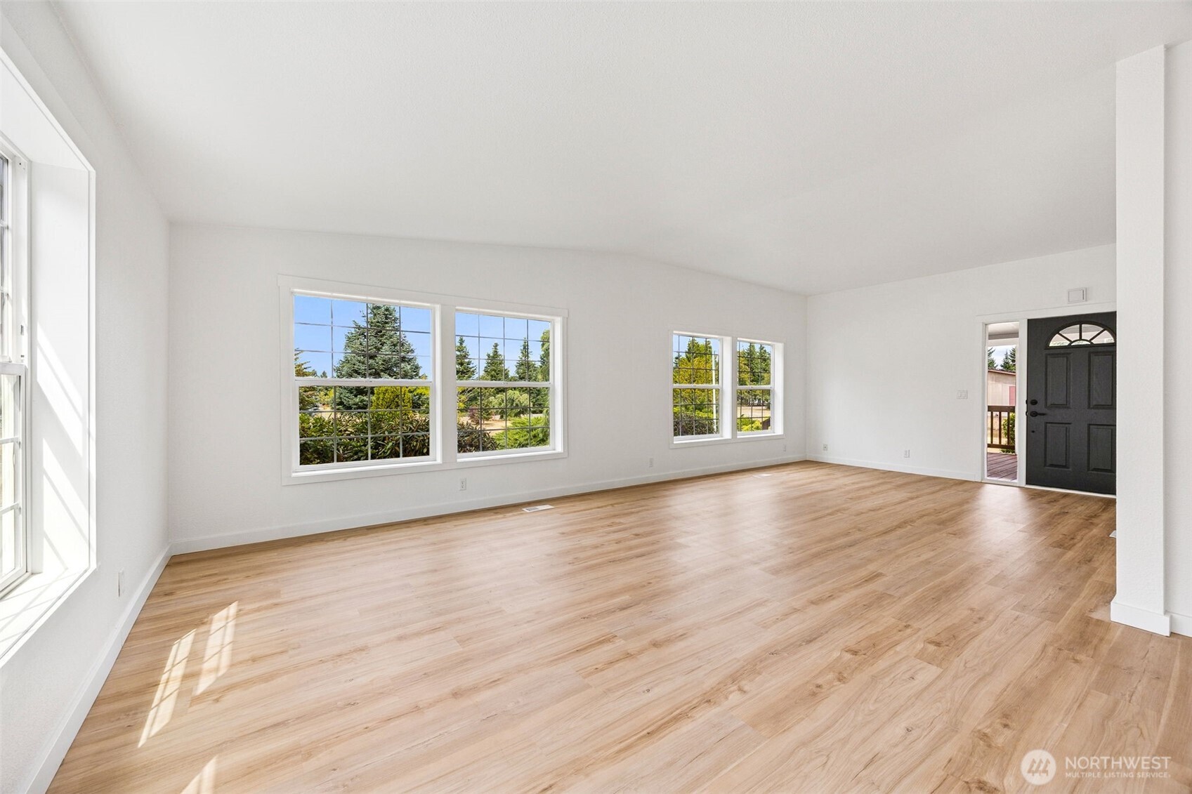 125 Highland Road Winlock, WA 98596 - Photo 7 of 40 an empty room with wooden floor and windows