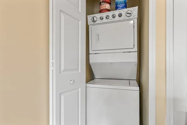 an empty room with windows and ceiling fan