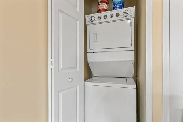 an empty room with windows and ceiling fan
