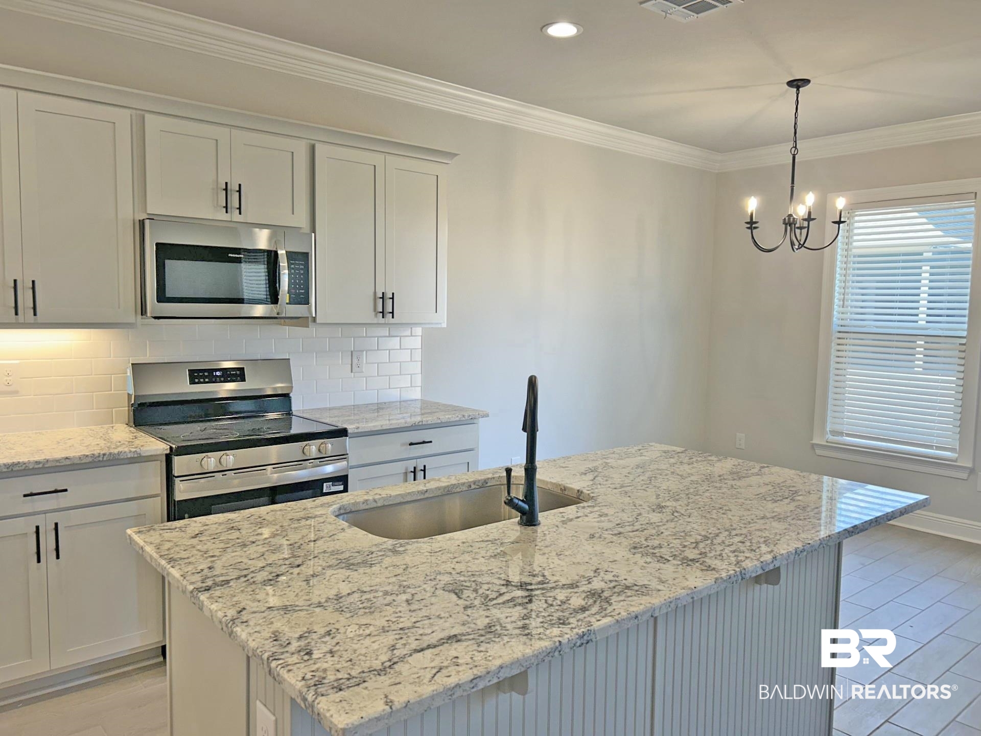 1748 Breckinridge Place Foley, AL 36535 - Photo 8 of 25 Kitchen featuring stainless steel appliances, decorative backsplash, light stone countertops, crown molding, and white cabinetry