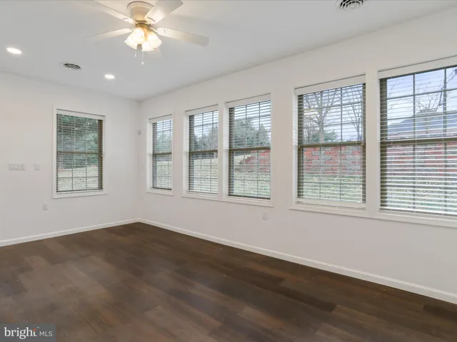 a view of an empty room and a bathroom