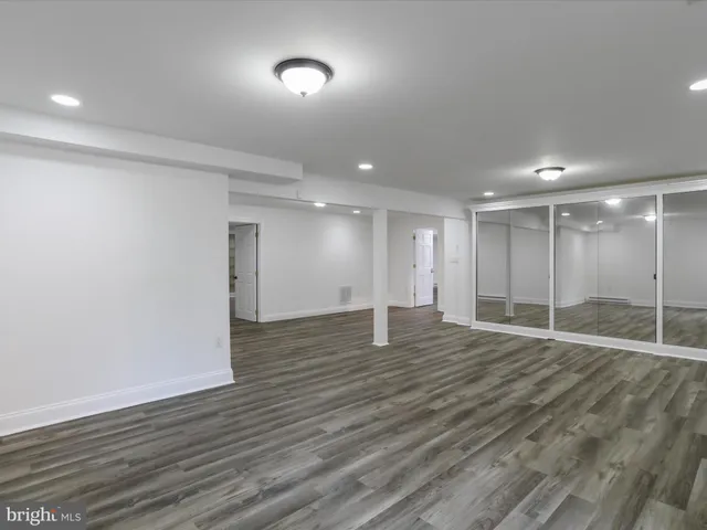 a large kitchen with kitchen island granite countertop a large counter top cabinets and stainless steel appliances