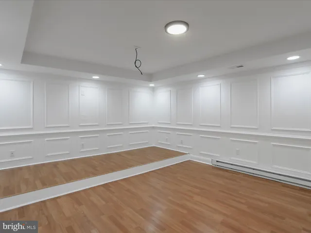 a dining room with furniture a chandelier and wooden floor