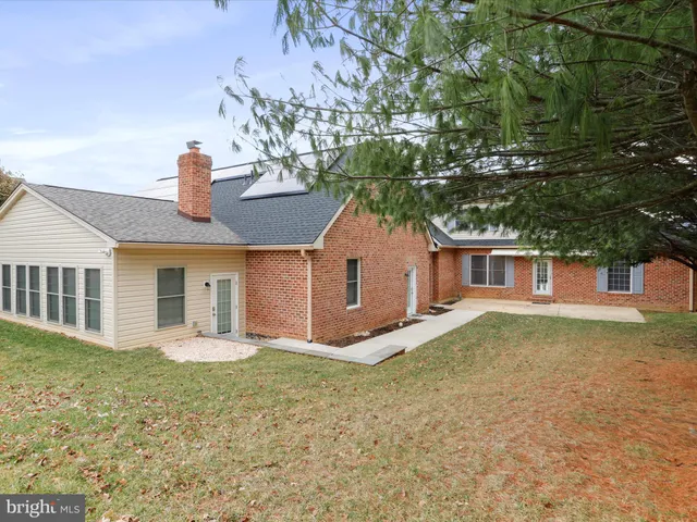 a kitchen with kitchen island granite countertop stainless steel appliances a sink stove refrigerator and cabinets