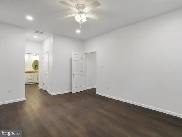 a bathroom with a double vanity sink toilet and shower