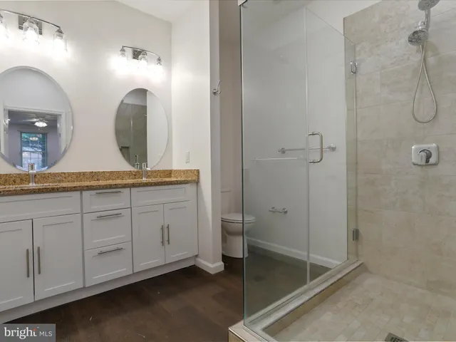 a bathroom with a sink a toilet and a mirror