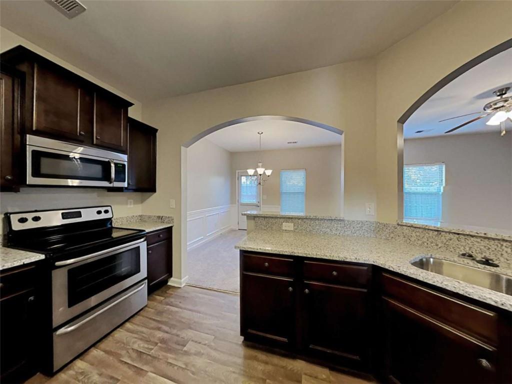 3144 Broadleaf Trail Road Fairburn, GA 30213 - Photo 8 of 21 a kitchen with stainless steel appliances granite countertop a sink and a stove