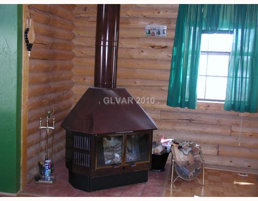265 Rim Las Vegas, NV 89124 - Photo 4 of 9 Den. Woodburning fireplace in Living Room