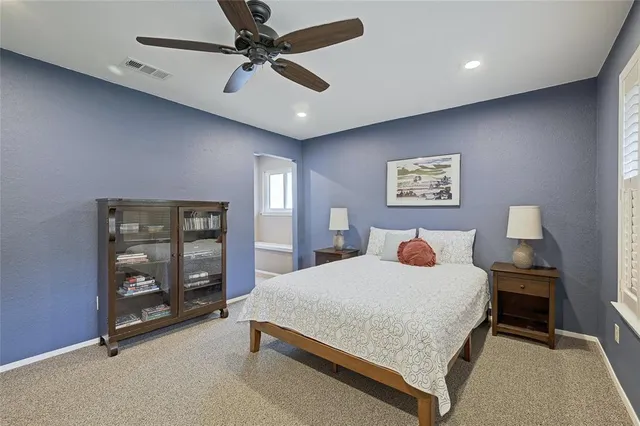 a bedroom with a bed a dresser and a book shelf