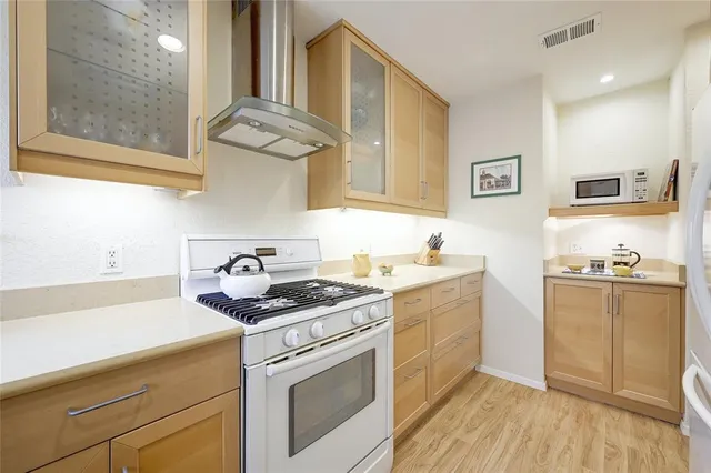 a kitchen with stainless steel appliances granite countertop a stove and a sink