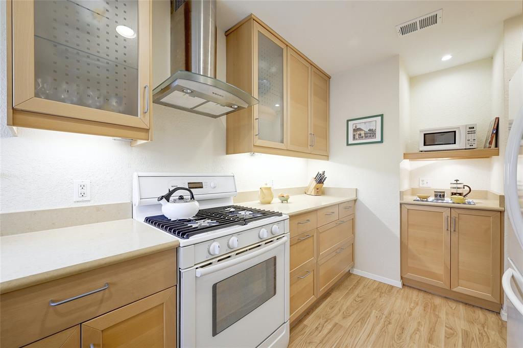 8507 Selway Drive Austin, TX 78736 - Photo 13 of 22 a kitchen with stainless steel appliances granite countertop a stove and a sink