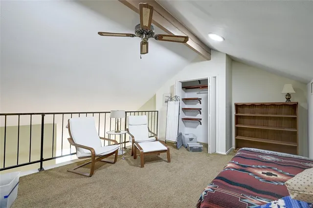 a living room with a couch and a ceiling fan